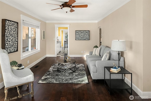 living room featuring ceiling fan, ornamental molding, and dark hardwood / wood-style floors