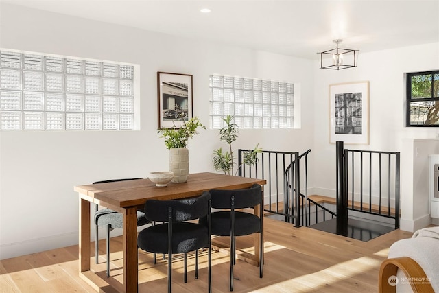 dining room featuring an inviting chandelier and light wood-type flooring