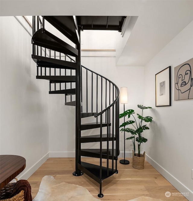 stairway featuring hardwood / wood-style flooring