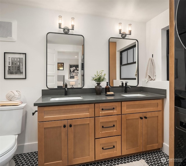 bathroom with vanity, tile patterned flooring, and toilet