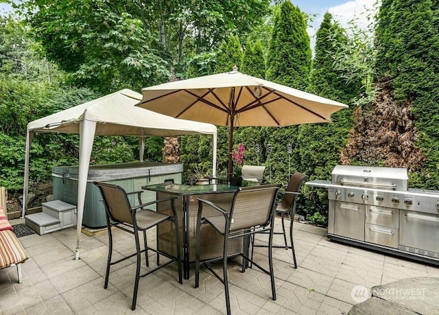 view of patio with a hot tub and an outdoor bar