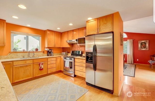 kitchen with stainless steel appliances, sink, and light wood-type flooring