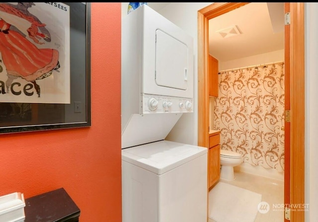 laundry room with stacked washer / dryer