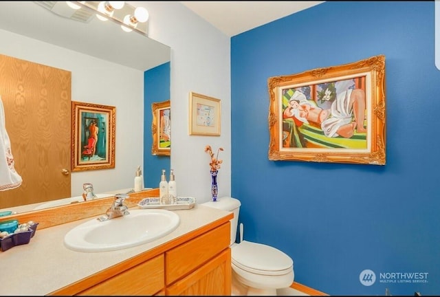 bathroom with vanity and toilet