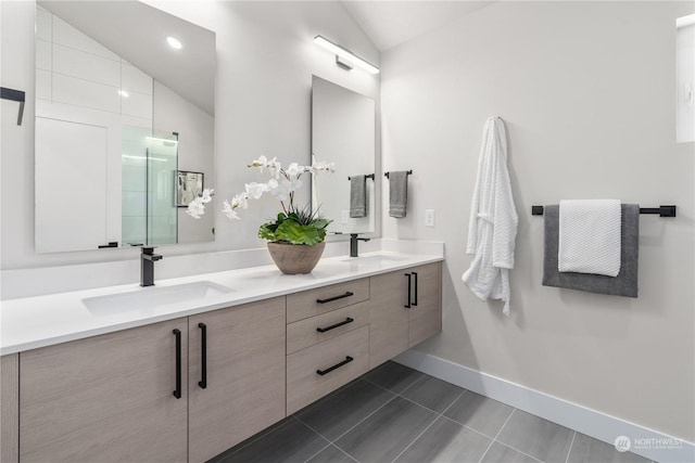 bathroom featuring tile patterned flooring, vanity, and lofted ceiling