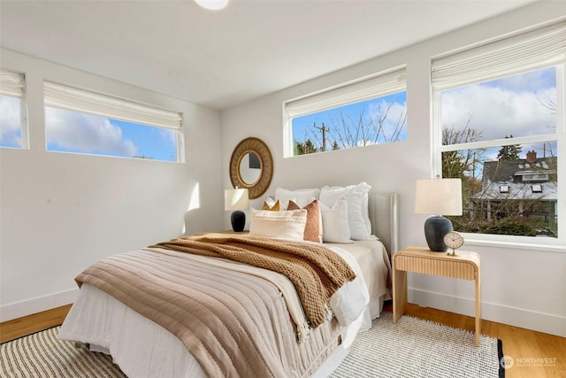 bedroom with hardwood / wood-style flooring