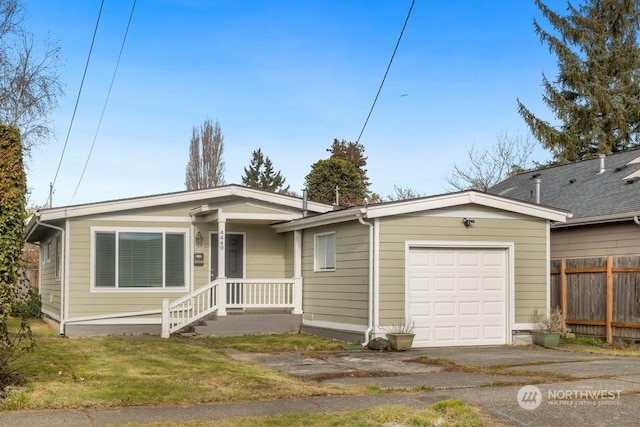 view of front of home with aphalt driveway, a front yard, fence, and an attached garage