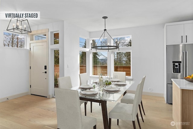 dining space featuring a chandelier and light hardwood / wood-style floors