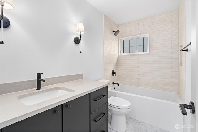 full bathroom with vanity, tiled shower / bath, and toilet