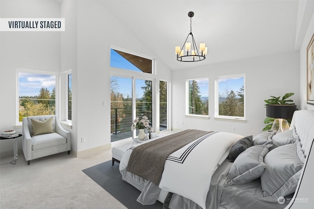 bedroom featuring multiple windows, carpet flooring, access to exterior, and a chandelier