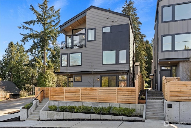 view of front of home featuring stairs and a balcony