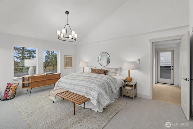 carpeted bedroom with baseboards, a chandelier, and vaulted ceiling