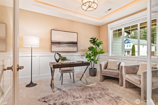 carpeted office featuring visible vents, a raised ceiling, wainscoting, french doors, and a decorative wall