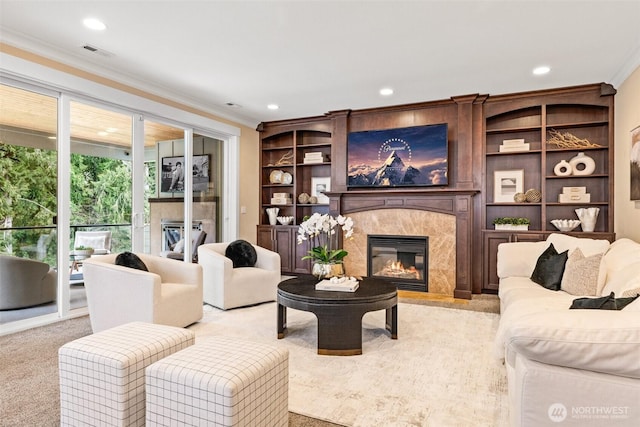 living area featuring recessed lighting, carpet flooring, visible vents, a high end fireplace, and ornamental molding