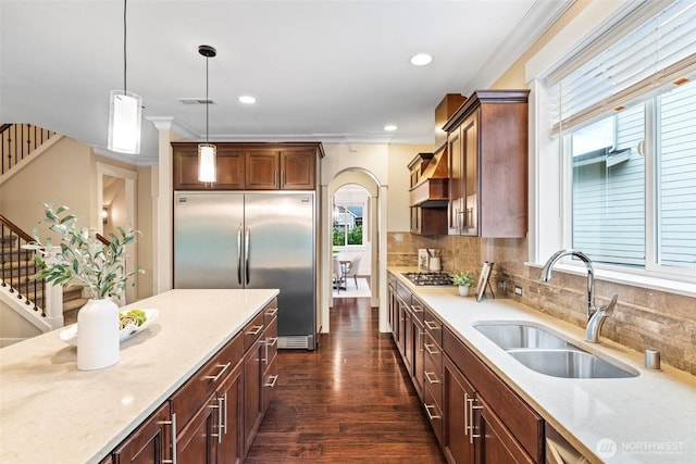 kitchen with visible vents, dark wood finished floors, stainless steel appliances, pendant lighting, and a sink