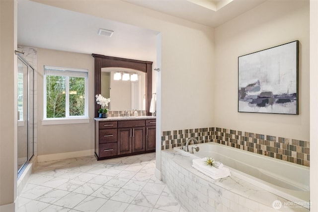 full bathroom with a stall shower, marble finish floor, a garden tub, and vanity