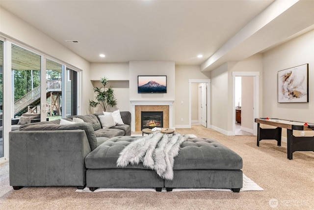 carpeted living room featuring recessed lighting, baseboards, visible vents, and a glass covered fireplace