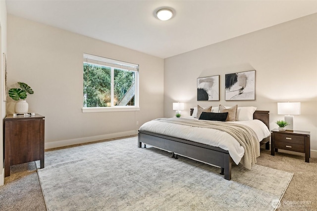 bedroom with carpet floors and baseboards