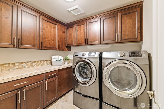 laundry area featuring cabinet space and washer and clothes dryer