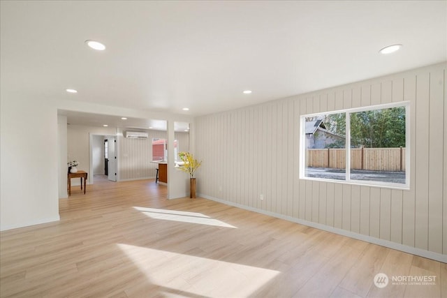 spare room with light hardwood / wood-style flooring and a wall mounted AC