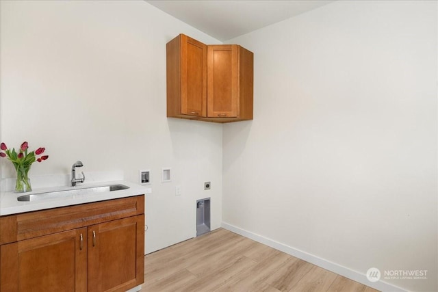 washroom featuring sink, cabinets, electric dryer hookup, washer hookup, and light hardwood / wood-style floors