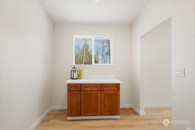 bar with light hardwood / wood-style flooring