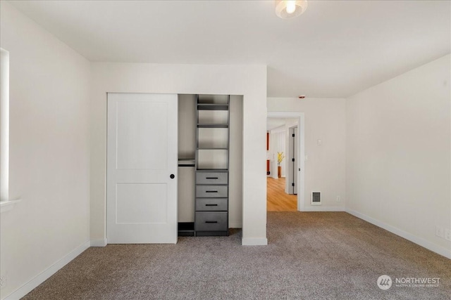 unfurnished bedroom featuring a closet and carpet