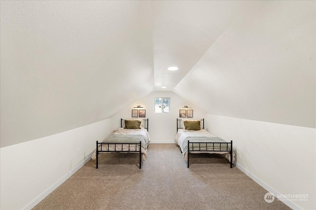 carpeted bedroom featuring lofted ceiling