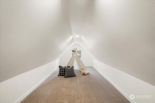 recreation room featuring lofted ceiling and carpet flooring