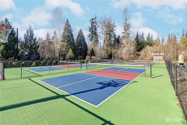 view of tennis court featuring basketball hoop