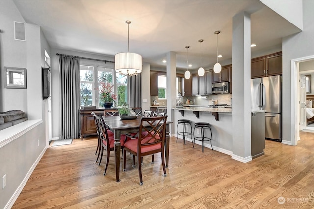 dining space featuring light wood-type flooring