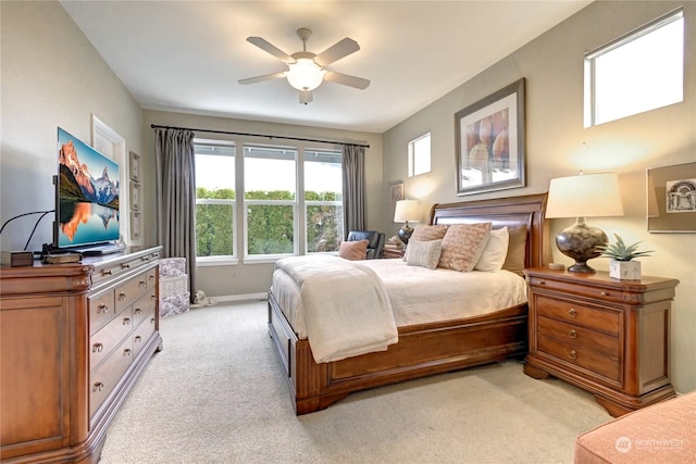 bedroom featuring light carpet and ceiling fan