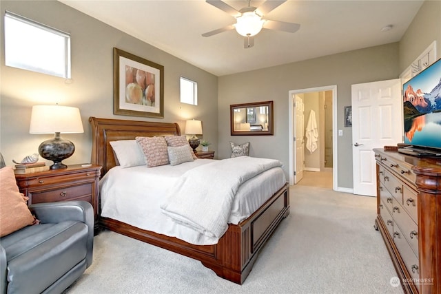 carpeted bedroom with ceiling fan and ensuite bath