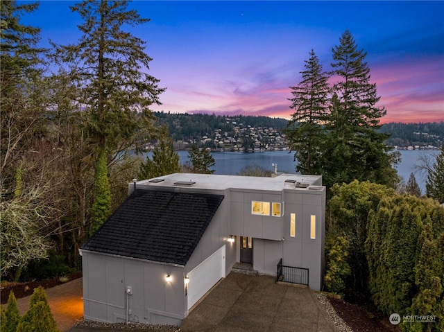 view of front of home with a water view and a garage