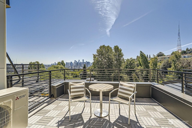 balcony with ac unit and a city view