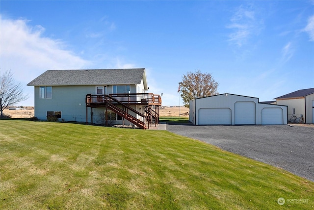 view of front of property featuring a garage, a wooden deck, an outdoor structure, and a front lawn