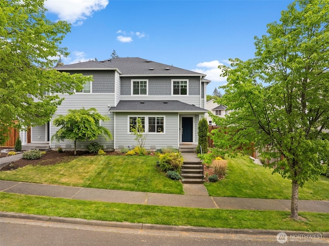 traditional home featuring a shingled roof and a front lawn