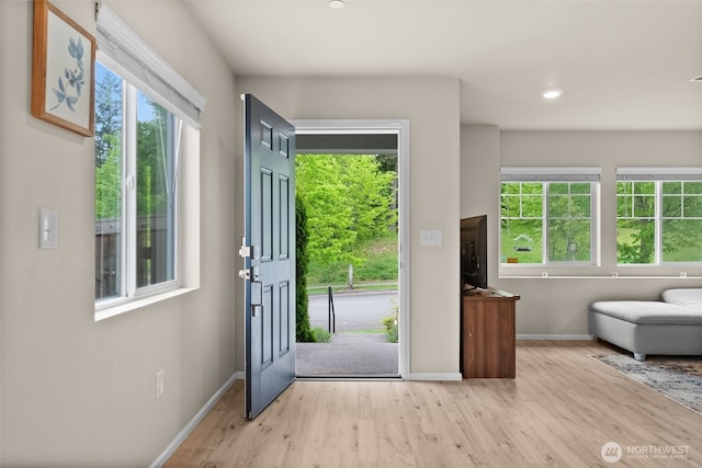 entryway featuring baseboards, recessed lighting, and light wood-style flooring