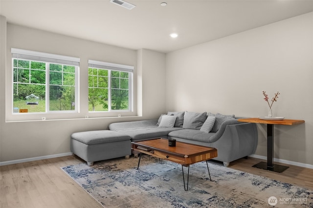 living room featuring baseboards, recessed lighting, wood finished floors, and visible vents