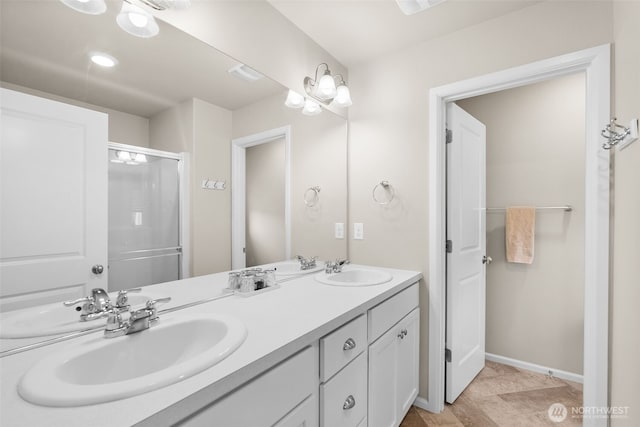 bathroom featuring double vanity, a sink, visible vents, and a shower stall