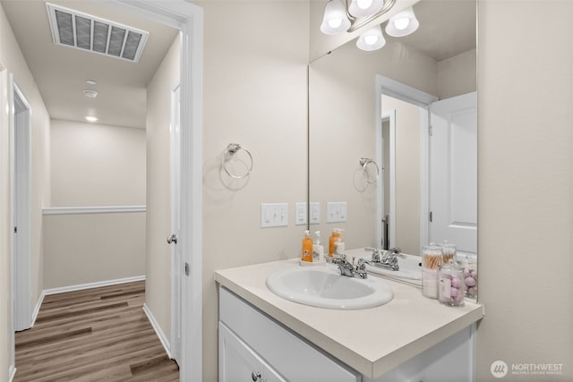 bathroom with vanity, wood finished floors, and visible vents