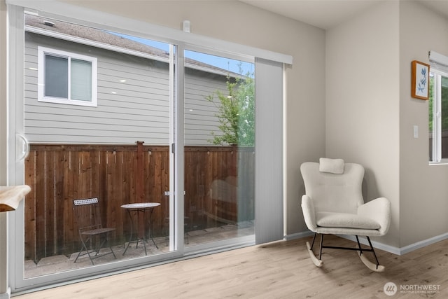 interior space with baseboards and wood finished floors