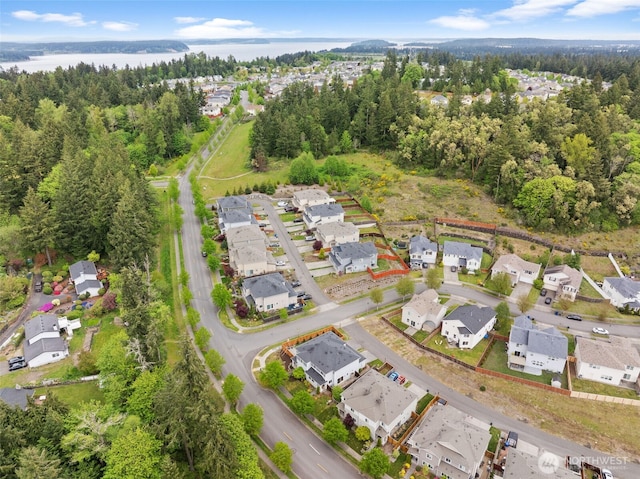 birds eye view of property featuring a residential view and a wooded view