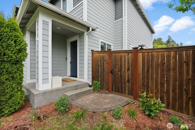 view of exterior entry with fence