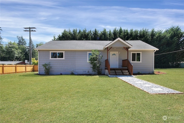 single story home featuring a front lawn