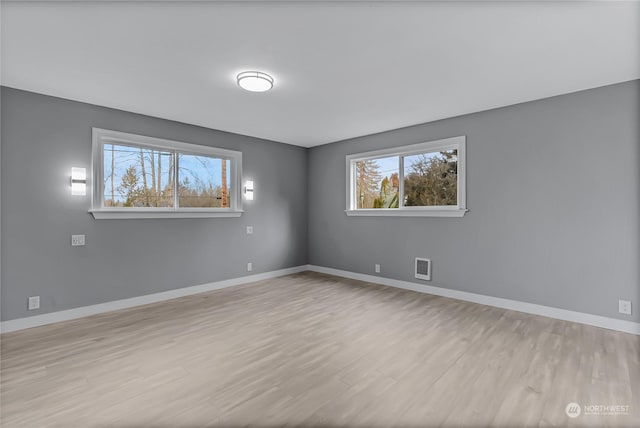 empty room with light hardwood / wood-style flooring