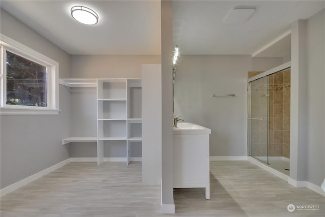 bathroom featuring vanity, an enclosed shower, and hardwood / wood-style floors