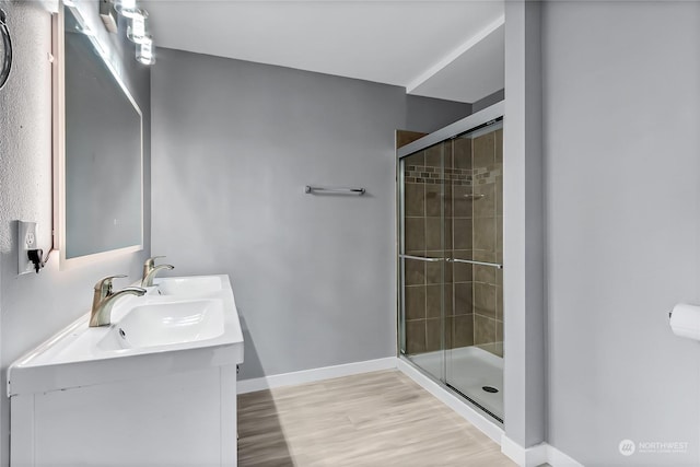 bathroom with vanity, hardwood / wood-style flooring, and walk in shower