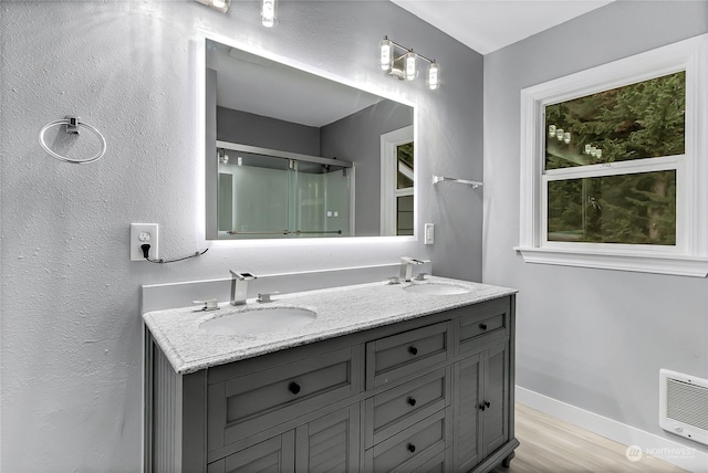 bathroom with vanity, wood-type flooring, and a shower with shower door