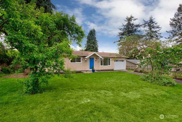 ranch-style home with a garage and a front lawn